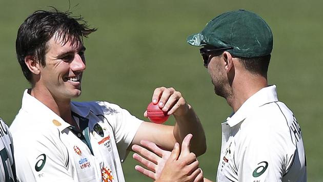 Australia's Josh Hazlewood, right, is handed the ball by teammate Pat Cummins after Hazlewood took 5 wickets against India on the third day of their cricket test match at the Adelaide Oval in Adelaide, Australia, Saturday, Dec. 19, 2020. (AP Photo/David Mairuz)(AP) Australia's Josh Hazlewood, right, is handed the ball by teammate Pat Cummins after Hazlewood took 5 wickets against India on the third day of their cricket test match at the Adelaide Oval in Adelaide, Australia, Saturday, Dec. 19, 2020. (AP Photo/David Mairuz)(AP)