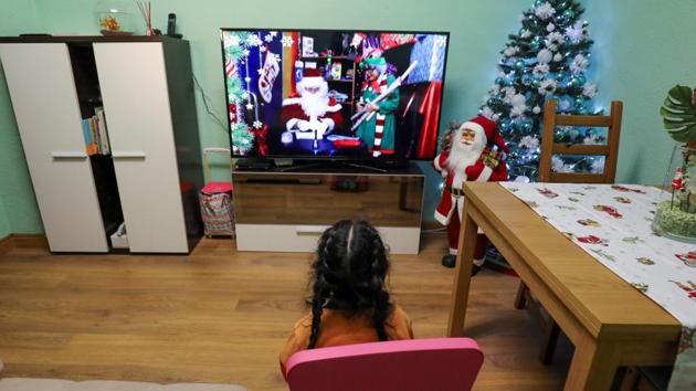 Arhoa Pena, 3, reacts as she watches a personalized Christmas video message. (REUTERS)