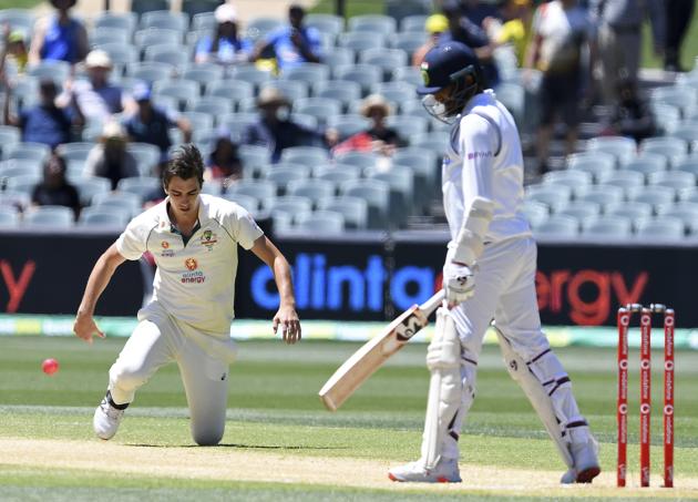 Australia's Pat Cummins, left, throws the ball in celebration after he caught and bowled India's Jasprit Bumrah, right, on the third day of their cricket test match at the Adelaide Oval in Adelaide, Australia, Saturday, Dec. 19, 2020. (AP Photo/David Mairuz) (AP)