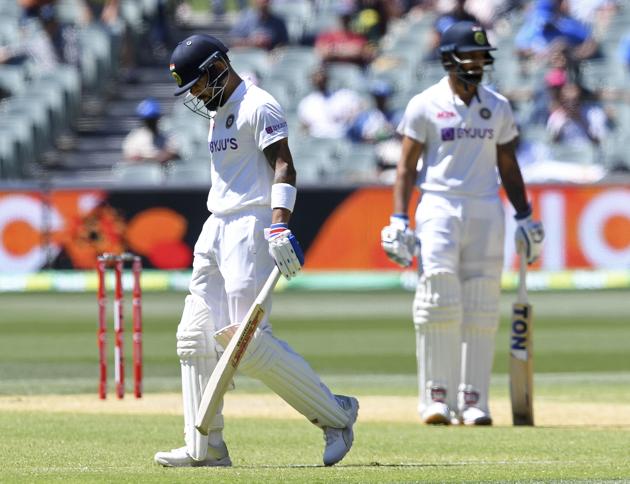 India's Virat Kohli, left, begins to walk off after he was caught out for 4 runs against Australia on the third day of their cricket test match at the Adelaide Oval in Adelaide, Australia, Saturday, Dec. 19, 2020. (AP Photo/David Mairuz) (AP)