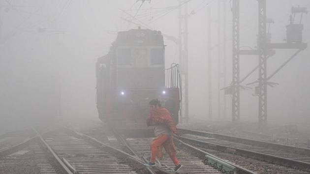 A woman crosses a railway track amid dense fog during a cold morning in Jalandhar on Friday. (PTI File Photo) A woman crosses a railway track amid dense fog during a cold morning in Jalandhar on Friday. (PTI File Photo)
