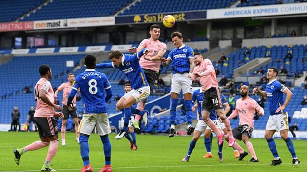 John Egan of Sheffield United battles for possession with Ben White of Brighton & Hove Albion.(Getty Images)