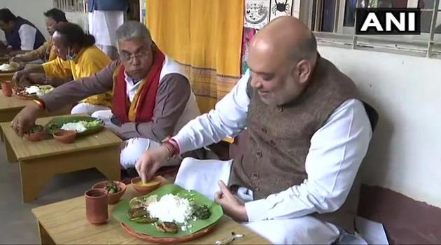 Amit Shah was served lunch on earthen dishes and bowls and water in an earthen glass in the courtyard of the house. Neighbours chipped in to help the eight-member family to prepare the lunch since morning amidst tight security. (ANI PHOTO.) Amit Shah was served lunch on earthen dishes and bowls and water in an earthen glass in the courtyard of the house. Neighbours chipped in to help the eight-member family to prepare the lunch since morning amidst tight security. (ANI PHOTO.)