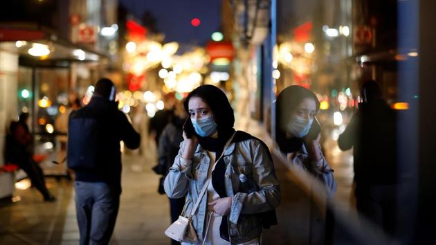 A woman speaks on the phone while walking past shops on Piccadilly on December 19. The toughest Tier 3 measures in the county of Kent have failed to stop the spread, prompting Johnson to introduce a new top level of infection controls, Tier 4. (Tolga Akmen / AFP) A woman speaks on the phone while walking past shops on Piccadilly on December 19. The toughest Tier 3 measures in the county of Kent have failed to stop the spread, prompting Johnson to introduce a new top level of infection controls, Tier 4. (Tolga Akmen / AFP)