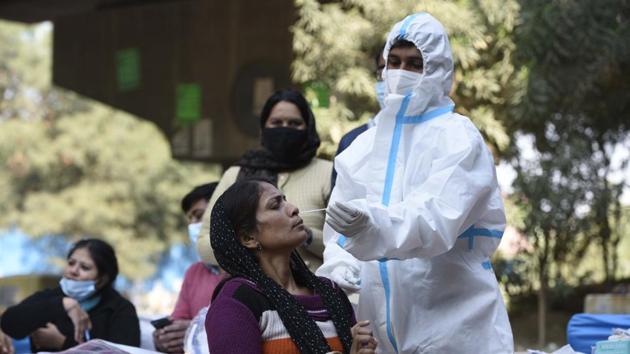 A medical worker collects a swab sample from a person for coronavirus disease (Covid-19) testing in Gurugram on Saturday. (Parveen Kumar/HT Photo) A medical worker collects a swab sample from a person for coronavirus disease (Covid-19) testing in Gurugram on Saturday. (Parveen Kumar/HT Photo)