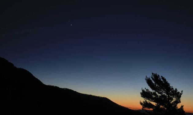 In this photo, Saturn is at the top and Jupiter is below. But the position will reverse on December 21 though they will appear as one big star.((Nasa))