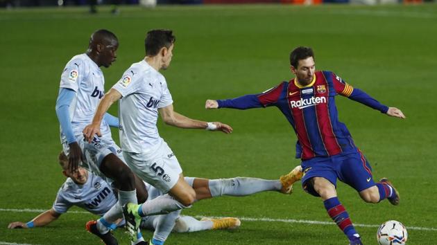 Barcelona:Barcelona's Lionel Messi, right, takes a shot at goal during the Spanish La Liga soccer match between Barcelona and Valencia at the Camp Nou stadium in Barcelona, Spain, Saturday, Dec. 19, 2020. AP/PTI Photo(AP20-12-2020_000008B) (AP) Barcelona:Barcelona's Lionel Messi, right, takes a shot at goal during the Spanish La Liga soccer match between Barcelona and Valencia at the Camp Nou stadium in Barcelona, Spain, Saturday, Dec. 19, 2020. AP/PTI Photo(AP20-12-2020_000008B) (AP)