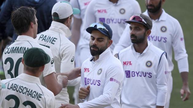India's Virat Kohli, center, shakes hands with Australian players on the third day of their cricket test match at the Adelaide Oval in Adelaide, Australia, Saturday, Dec. 19, 2020. Australia won the match. (AP Photo/David Mariuz)(AP)