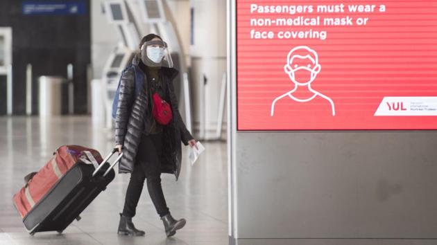 A woman walks through Montreal–Trudeau International Airport in Montreal on December 19, 2020. (AP) A woman walks through Montreal–Trudeau International Airport in Montreal on December 19, 2020. (AP)