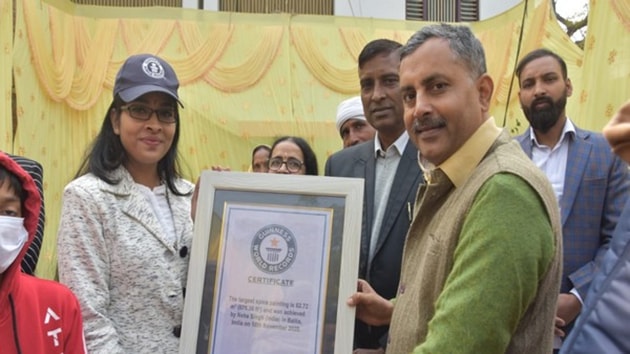 Ballia District Magistrate Shrihari Pratap Shahi giving Guinness World Record certificate to Neha Singh.(ANI)