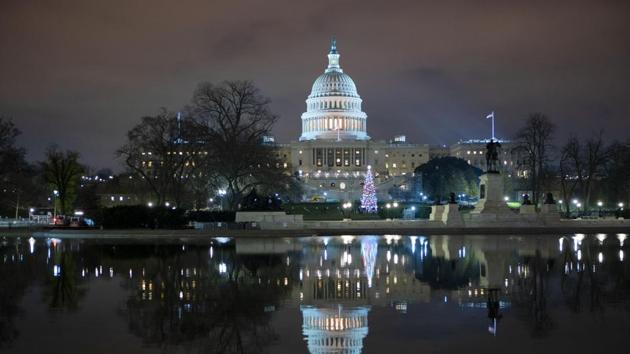 The US Capitol seen at night after negotiators sealed a deal for Covid relief on Sunday, finally delivering long-overdue help to businesses and individuals and providing money to deliver vaccines to a nation eager for them.(AP)