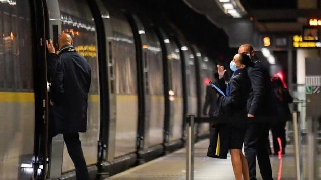 Train personnel wave to each other as one of them boards the last scheduled Eurostar train from London to Paris ahead of travel restrictions imposed by the French government on the UK, amid the Covid-19 pandemic in London. (Reuters Photo) Train personnel wave to each other as one of them boards the last scheduled Eurostar train from London to Paris ahead of travel restrictions imposed by the French government on the UK, amid the Covid-19 pandemic in London. (Reuters Photo)