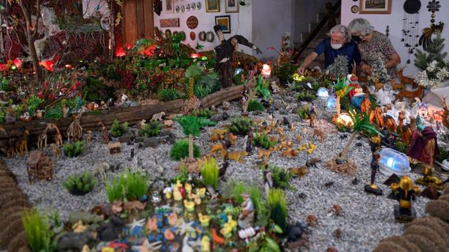 Iria (R) and Joao de Castro, who have been building a nativity scene with over 900 pieces for over 80 years, are seen at their home in Santa Luzia, Brazil on December 21. Brazil ranks third in total Covid-19 cases recorded in a country. (Douglas Magno / AFP) Iria (R) and Joao de Castro, who have been building a nativity scene with over 900 pieces for over 80 years, are seen at their home in Santa Luzia, Brazil on December 21. Brazil ranks third in total Covid-19 cases recorded in a country. (Douglas Magno / AFP)