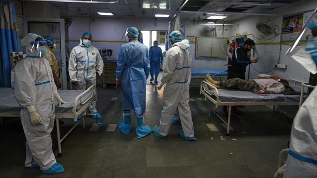 Medical professionals in PPE attend to a patient in the Covid-19 ward at Lok Nayak Jai Prakash Hospital (LNJP) in New Delhi. (Biplov Bhuyan/HT PHOTO) Medical professionals in PPE attend to a patient in the Covid-19 ward at Lok Nayak Jai Prakash Hospital (LNJP) in New Delhi. (Biplov Bhuyan/HT PHOTO)