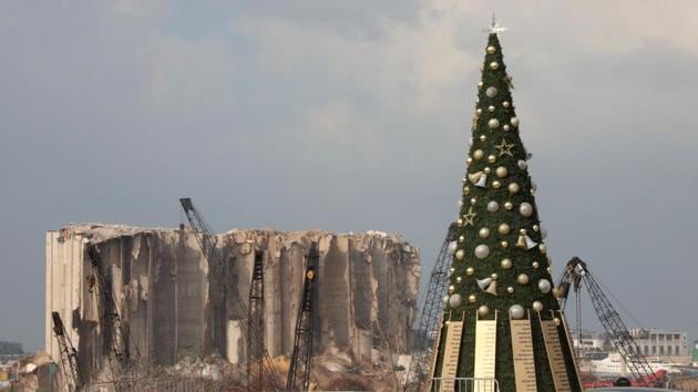 A Christmas tree with names of the Beirut port explosion victims is seen near the damaged grain silo, in Beirut, Lebanon on December 22. On August 4, 2020, a large amount of ammonium nitrate stored at the port of Beirut exploded, causing at least 204 deaths and 6,500 injuries. (Mohamed Azakir / REUTERS) A Christmas tree with names of the Beirut port explosion victims is seen near the damaged grain silo, in Beirut, Lebanon on December 22. On August 4, 2020, a large amount of ammonium nitrate stored at the port of Beirut exploded, causing at least 204 deaths and 6,500 injuries. (Mohamed Azakir / REUTERS)