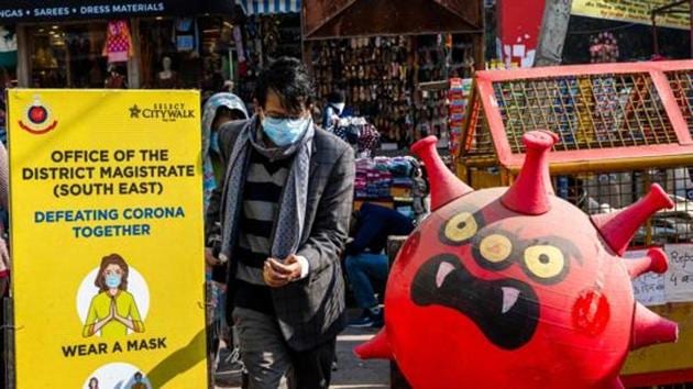 A man walks past a makeshift Covid-19 testing booth at a market area in New Delhi in this file photo.(AFP) A man walks past a makeshift Covid-19 testing booth at a market area in New Delhi in this file photo.(AFP)