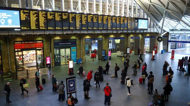 Travellers look at the information boards at King's Cross station, as EU countries impose a travel ban from the UK following the coronavirus disease outbreak, in London.(REUTERS)