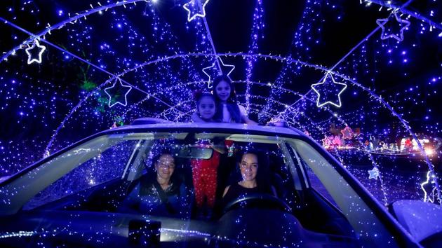 A family observes the Christmas decorations as they pass through the Santa’s Village Drive-Thru in Guadalajara, Mexico on December 20. (Ulises Ruiz / AFP) A family observes the Christmas decorations as they pass through the Santa’s Village Drive-Thru in Guadalajara, Mexico on December 20. (Ulises Ruiz / AFP)