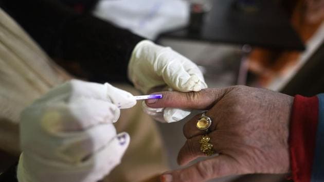 A polling officer puts an ink mark on the finger of a voter during the third phase of District Development Council (DDC) Election in Khallmullah area of Ganderbal, in Srinagar, Jammu and Kashmir. (Photo by Waseem Andrabi/ Hindustan Times) A polling officer puts an ink mark on the finger of a voter during the third phase of District Development Council (DDC) Election in Khallmullah area of Ganderbal, in Srinagar, Jammu and Kashmir. (Photo by Waseem Andrabi/ Hindustan Times)