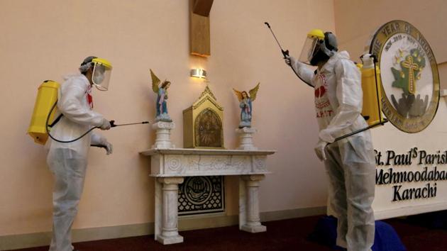 Volunteers spray disinfectant in the main hall of St Paul’s Parish ahead of Christmas celebrations in Karachi, Pakistan on December 22. (Fareed Khan / AP) Volunteers spray disinfectant in the main hall of St Paul’s Parish ahead of Christmas celebrations in Karachi, Pakistan on December 22. (Fareed Khan / AP)