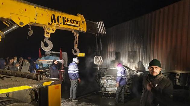 Police personnel near the charred remains of a car which collided with a tanker truck on the Yamuna Expressway under Khandauli police station in Agra district, in the wee hours of Tuesday, Dec. 22, 2020. Five people travelling in the car were charred to death. (PTI) Police personnel near the charred remains of a car which collided with a tanker truck on the Yamuna Expressway under Khandauli police station in Agra district, in the wee hours of Tuesday, Dec. 22, 2020. Five people travelling in the car were charred to death. (PTI)