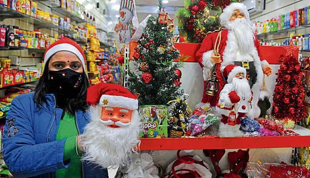 A woman browsing through Santa figurines and Christmas trees at Sector-11 market in Chandigarh on Tuesday. (KESHAV SINGH/HT) A woman browsing through Santa figurines and Christmas trees at Sector-11 market in Chandigarh on Tuesday. (KESHAV SINGH/HT)