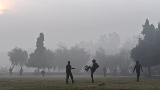 People play football at Sanjay Lake Park in New Delhi on December 22. The maximum temperature recorded on December 22 was 23.9 degrees Celsius. (Ajay Aggarwal / HT Photo)