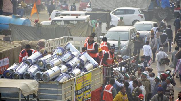Portable water heaters being distributed among demonstrators near the Ghazipur border protest site. (Photo by Sakib Ali /Hindustan Times)