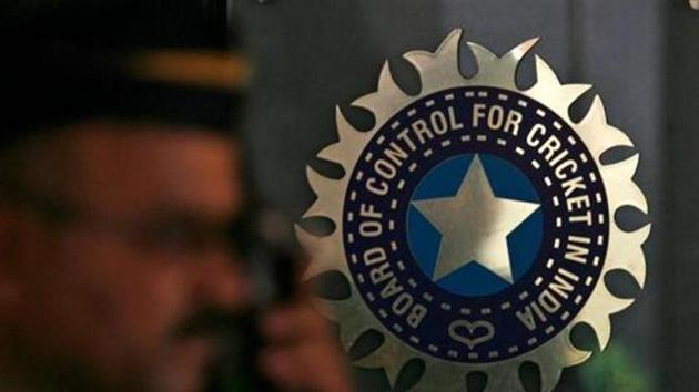 A policeman walks past a logo of the Board of Control for Cricket in India (BCCI).(REUTERS)