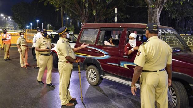 Police officers stop commuters at Girgaum Chowpatty during night curfew in Mumbai, early December 23. The police have heightened checking of vehicles during nakabandi (road blockade) at night and are ensuring no unnecessary movement of more than five persons in any area, a police official told PTI. (Kunal Patil / PTI) Police officers stop commuters at Girgaum Chowpatty during night curfew in Mumbai, early December 23. The police have heightened checking of vehicles during nakabandi (road blockade) at night and are ensuring no unnecessary movement of more than five persons in any area, a police official told PTI. (Kunal Patil / PTI)