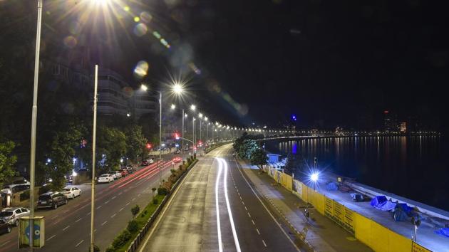Trails of light from passing vehicles at Marine Drive in this long exposure image, early December 23. Those involved in emergency, medical and essential services are exempted from the government order. (Kunal Patil / PTI) Trails of light from passing vehicles at Marine Drive in this long exposure image, early December 23. Those involved in emergency, medical and essential services are exempted from the government order. (Kunal Patil / PTI)