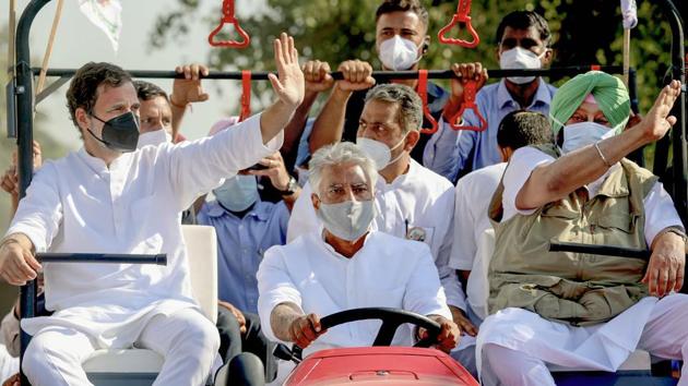 Congress leader Rahul Gandhi and Punjab chief minister Capt. Amarinder Singh ride a tractor driven by PPCC President Sunil Kumar Jakhar during their 'Kheti Bachao Yatra' over new farm laws, in Sangrur district in October.(PTI File)