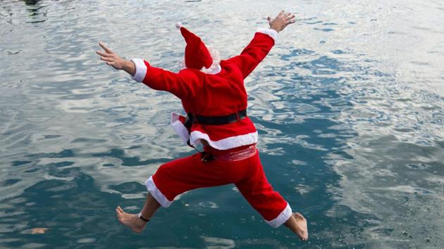 A participant in a Santa Claus costume jumps into the water during the 111th edition of the Copa Nadal (Christmas Cup) swimming race in Barcelona’s Port Vell on December 25. The traditional 200-meter Christmas swimming race gathered around 300 participants on Barcelona’s Port Vell. (Josep Lago / AFP)