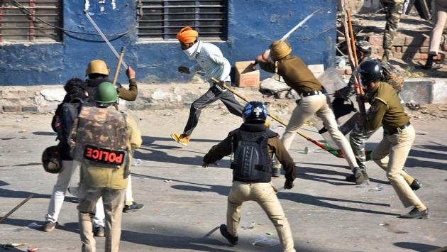 A farmer takes cover as Delhi Police personnel lathi-charge to disperse the farmers’ group at Singhu border near New Delhi on November 27. (Sanchit Khanna / HT Photo) A farmer takes cover as Delhi Police personnel lathi-charge to disperse the farmers’ group at Singhu border near New Delhi on November 27. (Sanchit Khanna / HT Photo)