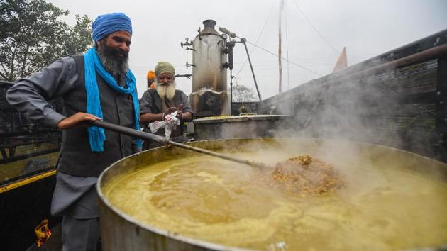 Meals being prepared at a community kitchen set up at the Singhu border protest site where farmers are camped in protest against new farm laws, near New Delhi on December 12. (Amal KS / HT Photo) Meals being prepared at a community kitchen set up at the Singhu border protest site where farmers are camped in protest against new farm laws, near New Delhi on December 12. (Amal KS / HT Photo)