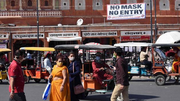 Commuters wearing facemasks as a preventive measure against the Covid-19 coronavirus make their way through a market in Jaipur. (AFP) Commuters wearing facemasks as a preventive measure against the Covid-19 coronavirus make their way through a market in Jaipur. (AFP)