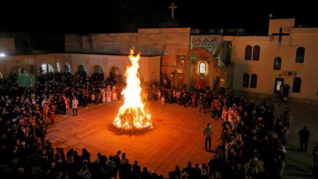 Devotees gathered around a fire as they attend a mass on Christmas Eve at the Grand Immaculate Church in al-Hamdaniya, near Mosul in Iraq on December 24. (Abdullah Rashid / REUTERS) Devotees gathered around a fire as they attend a mass on Christmas Eve at the Grand Immaculate Church in al-Hamdaniya, near Mosul in Iraq on December 24. (Abdullah Rashid / REUTERS)