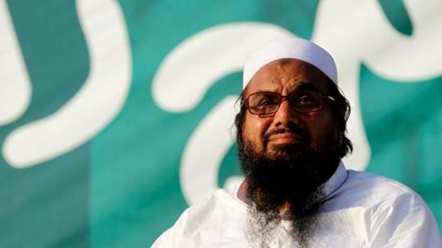 Hafiz Muhammad Saeed, chief of the banned Islamic charity Jamaat-ud-Dawah, looks over the crowd at a protest in Islamabad.(REUTERS)