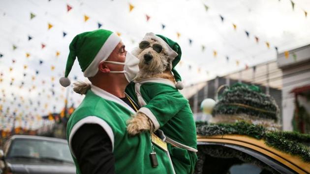 Nicolas Walteros, 52, carries his dog Coronel.(REUTERS)