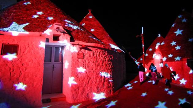 Pedestrians walk between Trulli, limestone buildings of Alberobello, a World Heritage Site, lit up with Christmas animations, in Italy on December 23. (Alessandro Garofalo / REUTERS) Pedestrians walk between Trulli, limestone buildings of Alberobello, a World Heritage Site, lit up with Christmas animations, in Italy on December 23. (Alessandro Garofalo / REUTERS)