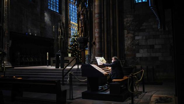 Church musician Gerd von der Heyde plays the organ at the St. Reinoldi church in Dortmund, Germany, on December 25. (Ina Fassbender / AFP) Church musician Gerd von der Heyde plays the organ at the St. Reinoldi church in Dortmund, Germany, on December 25. (Ina Fassbender / AFP)