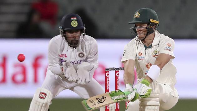 Australia's Tim Paine, right, plays a reverse sweep in front of India's Wriddhiman Saha on the second day of their cricket test match at the Adelaide Oval in Adelaide, Australia.(AP)