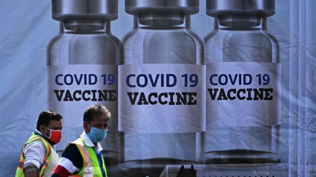 Members of ground staff walk past a container stacked at the Cargo Terminal 2 of the Indira Gandhi International Airport, which will be used as a Covid-19 vaccines handling and distribution centre, in New Delhi in this file photo. (AFP) Members of ground staff walk past a container stacked at the Cargo Terminal 2 of the Indira Gandhi International Airport, which will be used as a Covid-19 vaccines handling and distribution centre, in New Delhi in this file photo. (AFP)
