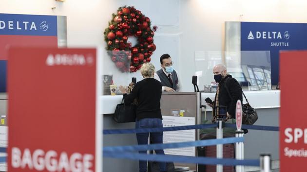People wearing protective masks check in for a Delta Air Lines Inc. flight at LaGuardia Airport (LGA) in New York, US. (Bloomberg) People wearing protective masks check in for a Delta Air Lines Inc. flight at LaGuardia Airport (LGA) in New York, US. (Bloomberg)