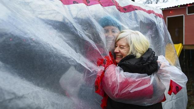Carolyn Ellis (L), creator of the hug glove, hugs her mother Susan Watts, 74, at her backyard on Christmas Eve in Guelph, Ontario, Canada on December 24. (Nathan Denette / The Canadian Press via AP) Carolyn Ellis (L), creator of the hug glove, hugs her mother Susan Watts, 74, at her backyard on Christmas Eve in Guelph, Ontario, Canada on December 24. (Nathan Denette / The Canadian Press via AP)