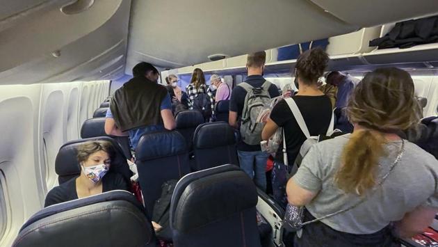 Passengers board an Air France flight bound for Paris at Johannesburg's OR Tambo airport on December 21. Boarding is a breeze when a plane is at less than 40% capacity. Passengers wearing designer cloth masks were politely requested to take them off and wear the universally acknowledged as effective light blue surgical mask, Delay recalled. (Jerome Delay / AP)