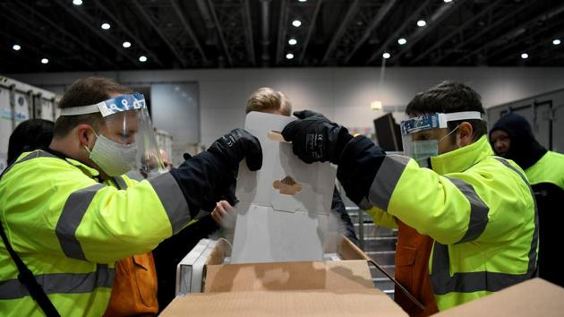 Boxes of Pfizer-BioNtech Covid-19 vaccine are unloaded after arriving at an undisclosed location in North Rhine Westphalia, Germany,(via Reuters)