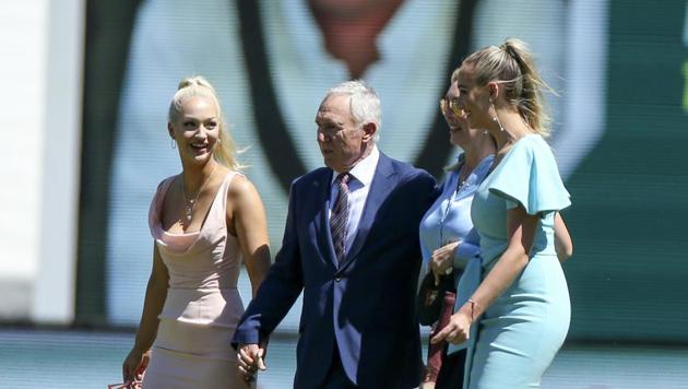 Former Australian cricket captain Allan Border walks with the daughters of former Australian cricketer Dean Jones, Phoebe (R) and Augusta (L) with their mother, Jane (Centre) during a tribute for the late batsman(AP)