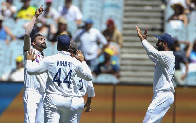 India's MD Siraj, left, celebrates after taking the wicket of Australia's Marnus Labuschagne during play on day one of the Boxing Day cricket test between India and Australia at the Melbourne Cricket Ground, Melbourne, Australia, Saturday, Dec. 26, 2020. (AP Photo/Asanka Brendon Ratnayake) (AP)