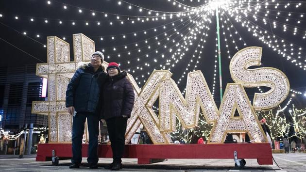 People pose for photos during 